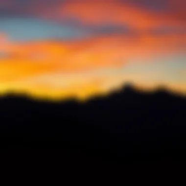 Mountains silhouetted against a fiery sunset sky